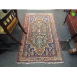 A Middle-Eastern hand knotted wool rug, foliate central motif, navy ground, multiple borders,