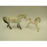 A Beswick Appaloosa- spotted walking pony in gloss, model no. 1516 together with a Wade foal