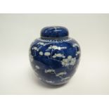 A Chinese ginger jar decorated with cherry blossom, complete with lid, character marks to base