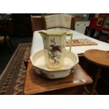 A Falconware wash jug and bowl decorated with birds and foliage