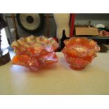 A collection of orange carnival glass bowls to include footed and pedestal examples (4)
