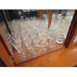A collection of glasswares including cut glass examples, jugs, wine glasses, etc