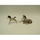 A Beswick foal, lying in Rockinghorse grey gloss, model no. 915 together with a Beswick foal-small