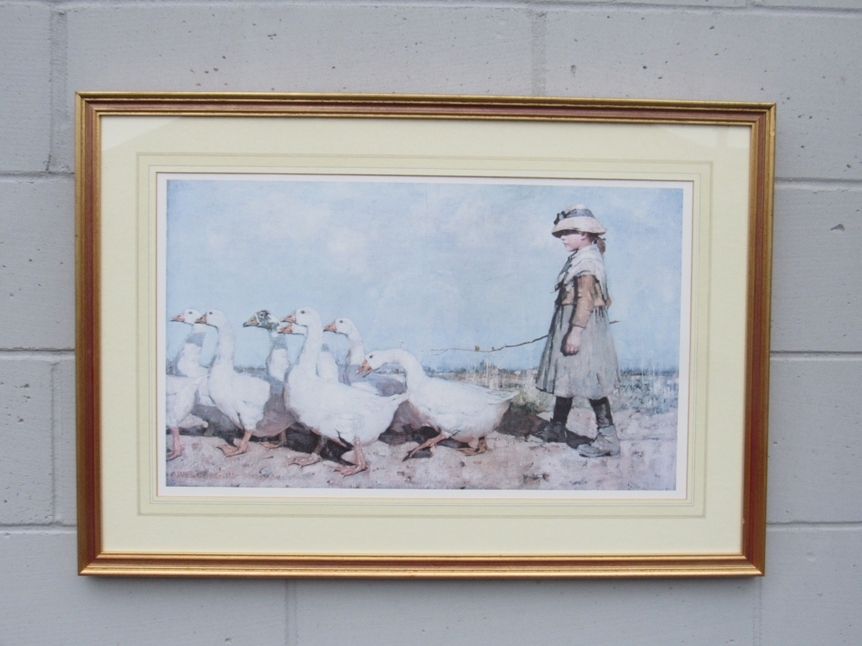 A framed and glazed print after James Guthie depicting a girl with geese. Image size 38cm x 64cm