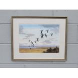 A framed and glazed print after John Cyril Harrison depicting Pink Footed Geese in flight. Signed in