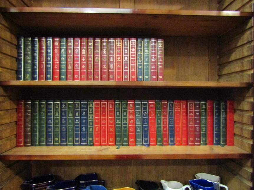 53 Readers' Digest First Edition Condensed Books with decorative gilt decorated hardback covers.