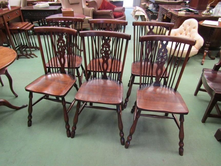 A 19th Century revival set of eight elm seat Thames Valley stick back dining chairs having a wheel