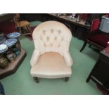 A Circa 1900 rounded top button back rest bedroom armchair the serpentine front seat over ring