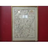 An embroidery backed onto linen depicting a map of Scotland with landmarks and figures, framed and