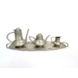 A Circa 1900 Urania pewter teapot, coffee pot and milk jug with integral tray, designed possibly