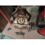 A wooden hand painted cuckoo clock