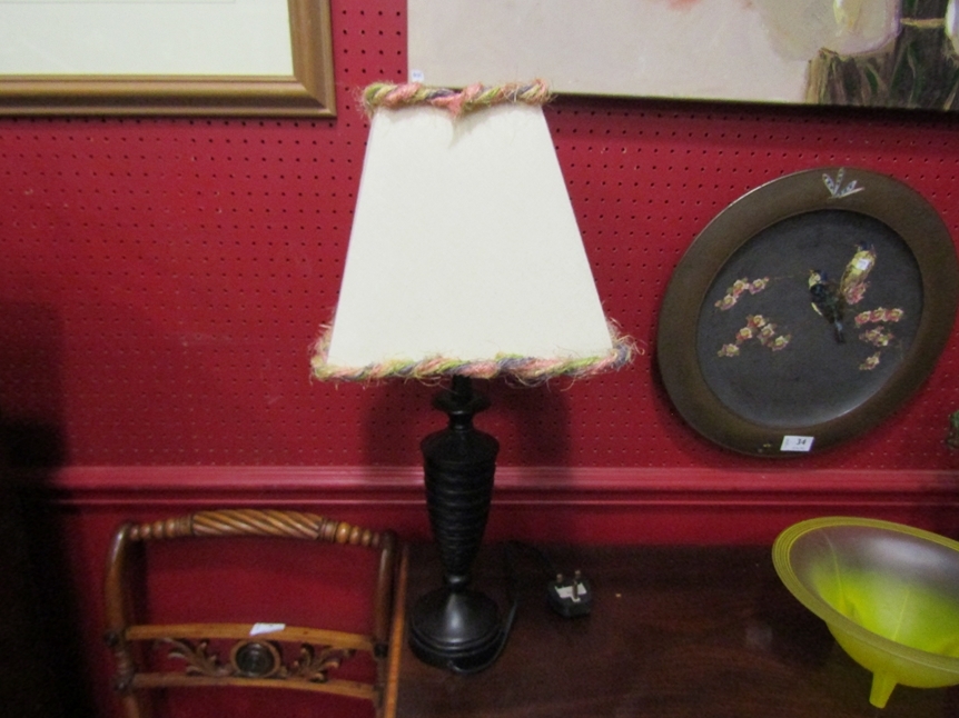 An ebony table lamp with bobbin turned base and cream design shade, 55cm tall