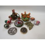 A wind-up tinplate toy, chickens feeding, painted stone, lion mask design weight, brass butterfly,