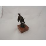 A late Victorian Austrian bronze figure of a portly gamekeeper and his dog on a rose marble base,