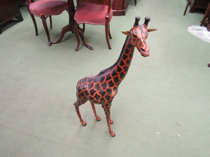 A leather covered giraffe figure, 85cm tall