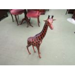 A leather covered giraffe figure, 85cm tall