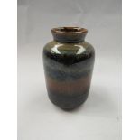 A glazed studio pottery vase with bands of colour. 10cm tall