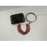 A tortoiseshell bangle with ball terminals, a foil back link bracelet and a faux tortoiseshell