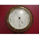 WITHDRAWN: An early 20th Century oak cased wall mounted barometer with rope twist carving. Overall