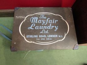 A box containing various glass lamp shades, box named "The Mayfair Laundry Ltd."
