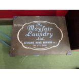 A box containing various glass lamp shades, box named "The Mayfair Laundry Ltd."