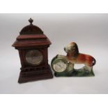 A wooden cased mantel clock with brass dial, together with a ceramic Lion clock, made in Germany