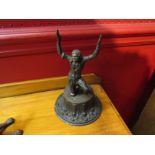 A Victorian cast metal figure of a slave on a pressed tinplate base, 18.5cm tall