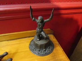 A Victorian cast metal figure of a slave on a pressed tinplate base, 18.5cm tall