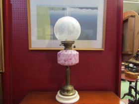 A Duplex English made oil lamp with etched glass globe shade over mottled glass reservoir, brass