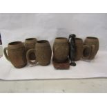 Six wooden carved mugs, a tray and ethnic figure (8)