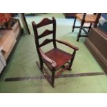 Circa 1800 an oak child's rocking chair the three rung ladder back rest with handpainted floral