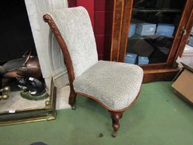 A circa 1860 rosewood slipper chair with carved acanthus leaf decoration on scroll feet and
