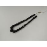 A carved and faceted jet bead necklace