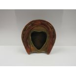 A horseshoe copper and brass photograph frame, 11.5cm tall