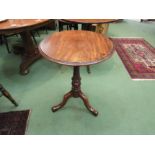 A mid Victorian walnut circular top wine table over a turned and spiral column on a tripod base.