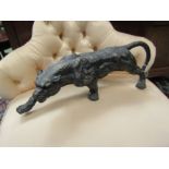 A bronzed effect figure of a prowling panther, 52cm long