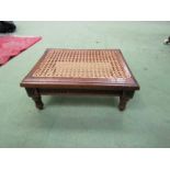 A late Victorian walnut stool with cane seat and painted gilt relief on carved and turned/reeded