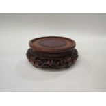 A Chinese 19th Century carved rosewood display stand for a vase. 20cm diameter