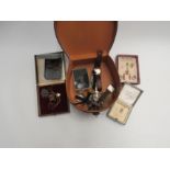 A leather box containing miscellaneous costume jewellery, watches etc.