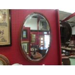 An Art Deco 1920's bevelled edge oval mahogany mirror, a/f, 64cm x 44cm