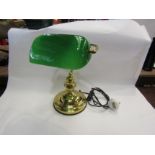 A brass based bankers lamp with green glass shade