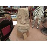 A stone carved head reputedly Welsh Celtic from Buith Wells, on oak plinth base, 48cm tall including