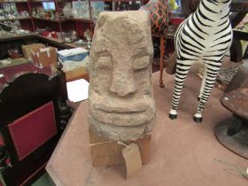 A stone carved head reputedly Welsh Celtic from Buith Wells, on oak plinth base, 48cm tall including