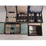 A quantity of cased flatware including cake knives, butter knives etc.