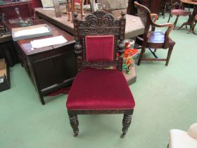 A late Victorian carved oak chair with Grecian bowl and acanthus leaf decoration the turned fore