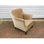 A 1940's Danish armchair with low back, stained hardwood legs, original beige velor upholstery