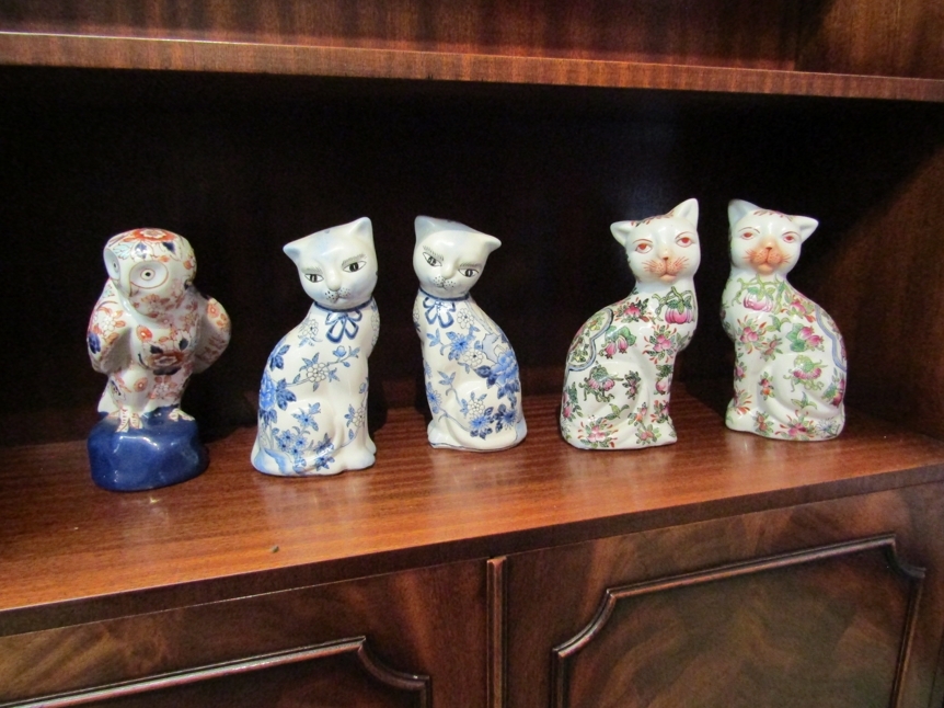 Five Oriental ceramic figures, an owl and two pairs of cats