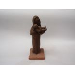 A terracotta figure, Mother and Child, indistinctly signed at base on plinth, 28cm tall