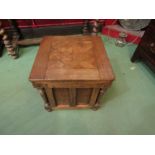 An oak commode with geometric cubed top, panel and column sides, 41cm x 42.5cm x 42.5cm