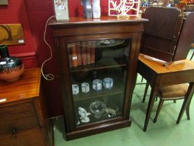 A late Victorian walnut bookcase, the single glazed door with working lock and key, the height